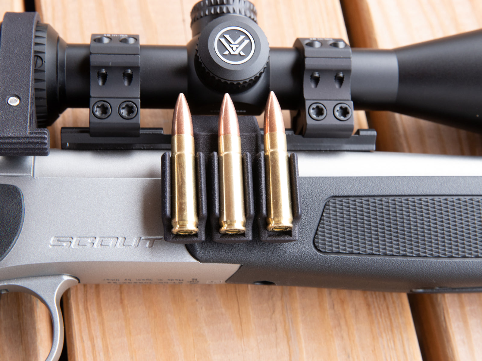 Ammo Carrier for CVA Scout Picatinny rail holding three .223 rounds on a rifle
