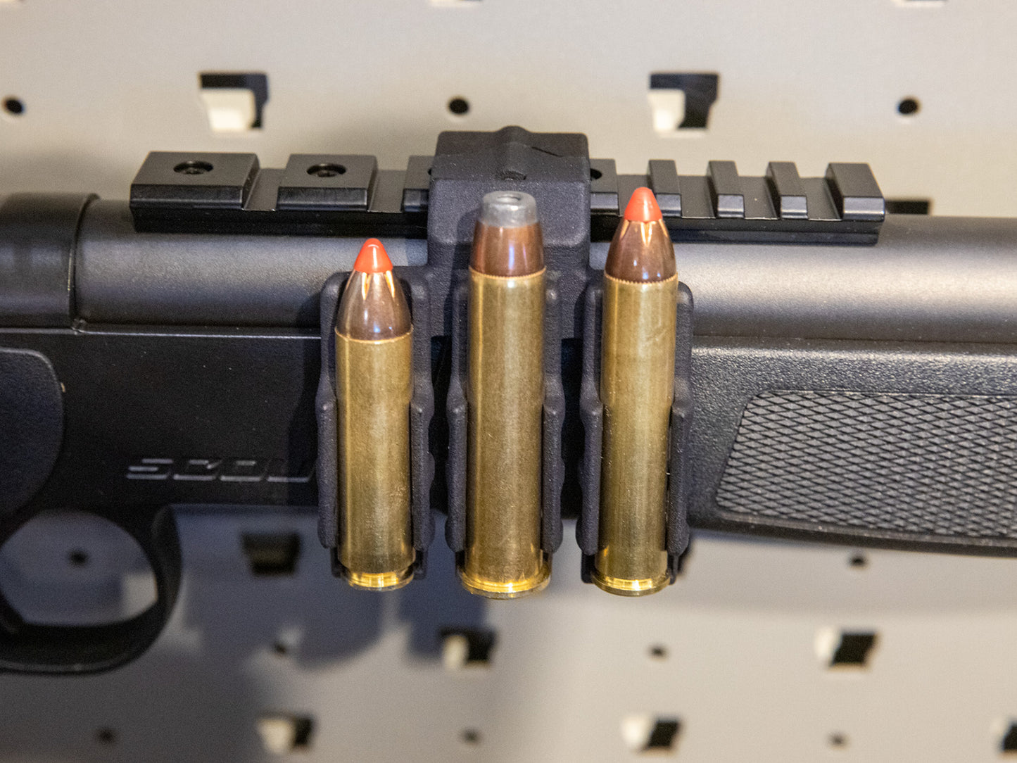 Ammo Carrier for CVA Scout Picatinny rail holding three .450 Bushmaster rounds on a rifle