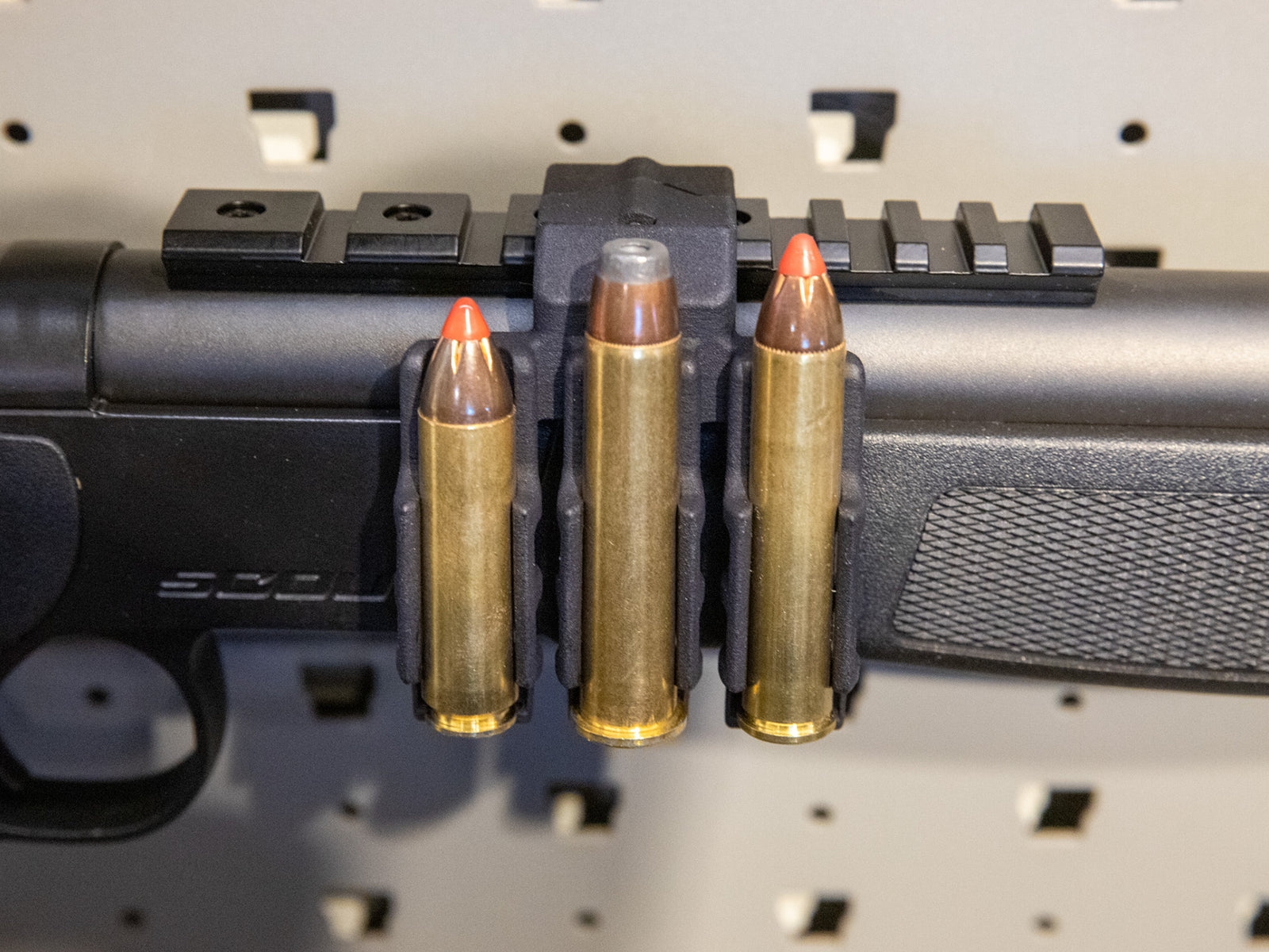 Ammo Carrier for CVA Scout Picatinny rail holding three .450 Bushmaster rounds on a rifle